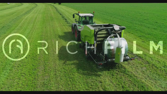 Aerial view of a tractor baling bales