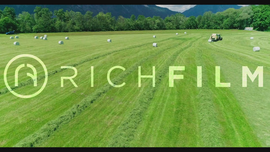 Aerial view of several tractors cultivating a field - V2