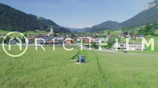 Aerial view of a tractor mowing in the field