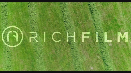 Aerial view of a tractor baling bales from above