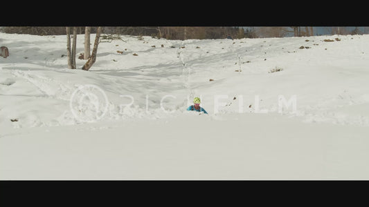 Shot of a mountain bikers riding through deep snow in winter