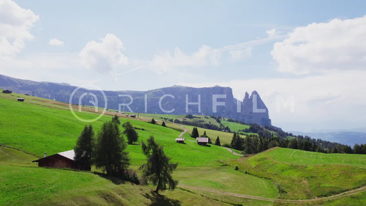 Aerial view of the Dolomites with forest and wooden huts