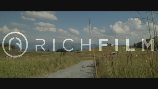 Slow motion shot of a cyclist riding down a hill in summer with a rotated perspective