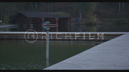 shot of the lake with forest and jetty in autumn