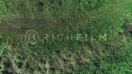 Aerial view of a mountain biker riding on a dirt track from a bird's eye view