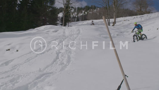 Slow-motion shot of a mountain biker in deep snow - V2